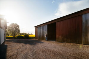 Barn on field against sky